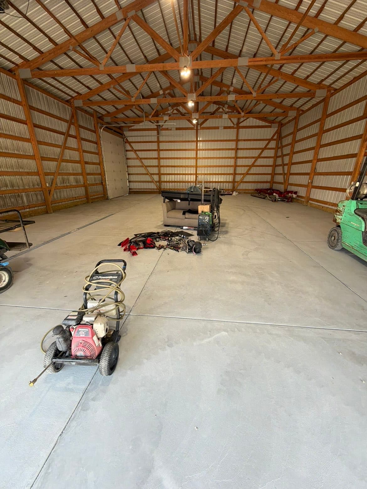 TP Customs LLC shop interior — pole barn with welding equipment and fabrication tools